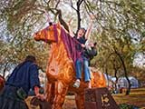 Denise and Gemini ride the giant rocking horse. © Denise Gary