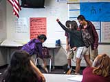 A “bully” knocks books out of another student's hands. © Robert Gary