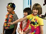 Kids participate in a hula song. © Denise Gary
