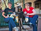 KNTR staffers Denise Gary and Debbie Brown enjoy their first shipment of New Mexico chips and salsa. © Robert Gary