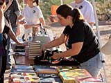 Volunteers arrange free books for the kids, provided by Changing Hands Bookstore.