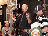 Allen Amis and Will Friedrichs get ready to raffle their <em>Star Wars</em> props to benefit KNTR at the Anarchy Squared Creations booth. © Bruce Matsunaga