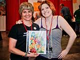 Kelly Ferguson stopped by the KNTR booth to drop off her art donation. © Robert Gary