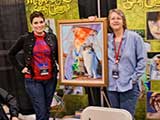 Tina Worley and Sarah Clemens stand with Sarah's art contribution. © Robert Gary
