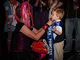 Denise tied up the sash to make it fit the little Prince. © Devon Christopher Adams