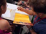 The kids enjoyed having Steven sign and draw an illustration inside their books. © Robert Gary