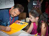 After signing a reading pledge, each participant received a backpack filled with goodies, including a <em>Highlights</em> or <em>Cricket</em> magazine and a copy of Steven's book, <em>Little Ty Cooney and the Grand Canyon Tour Company</em>. © Bruce Matsunaga