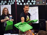 Steven hands out goodie backpacks, which were sponsored by Bookmans. © Carl Wagner