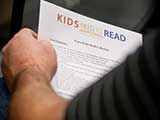 Attendees received a list of the Kids Need to Read “Peace Packs” book collection. © Bruce Matsunaga