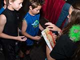 Peyton hands out magazines to the kids stopping by our booth. © Robert Gary