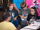 Kids talk to KNTR volunteer David. © Robert Gary