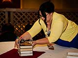 Lori Cothrun of Bookmans begins to assemble the table decorations. © Bruce Matsunaga