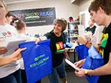Denise hands out goodie backpacks, sponsored by Bookmans. © Robert Gary