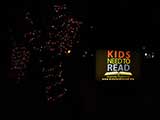 Holiday lights and the Kids Need to Read sign welcome partygoers. © Robert Gary