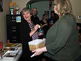 Denise tries to slyly pick a good number for the ornament exchange (aka cheating). © Robert Gary