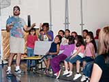 Marco handed out prizes as the kids correctly answered Shawn's questions. © Denise Gary