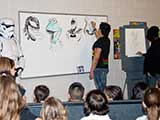 While Shawn talked about superheroes, the three illustrators sketched and the Stormtroopers kept a watchful eye. © Denise Gary