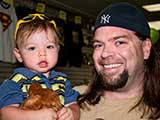 Todd Schumann of Hero Comics and his little superhero welcomed KNTR to Free Comic Book Day. © Denise Gary