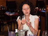 Marisa reads a door prize number. © Bruce Matsunaga