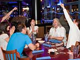 Denise and author Frank Beddor playfully cheer for mischief perpetrated upon PJ Haarsma. © Bruce Matsunaga