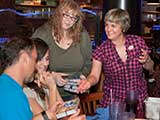 Debb and Denise hand out KNTR note cards as gifts to the calendar artists. © Bruce Matsunaga
