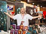 Author/KNTR founder PJ Haarsma was a guest in the KNTR booth. © Bruce Matsunaga