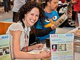 KNTR calendar artist Marisa Grieco signed calendars in the booth throughout the weekend. © Bruce Matsunaga