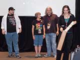 Michael Dougherty and Heather Fagan presented a <em>Browncoats: Redemption</em> ceremonial check to KNTR. © Bruce Matsunaga