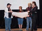 Denise and PJ accepted the check on behalf of KNTR. © Bruce Matsunaga