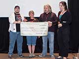 The amount reflected the $12,000 raised for KNTR through the <em>Redemption</em> project through May. © Bruce Matsunaga