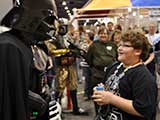 <em>Star Wars</em> fan Nicholas receives a 13th birthday cupcake from Darth Vader. Photo courtesy <em>Star Wars</em> Neighborhood