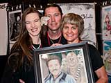 Artist Denae Frazier presents her <em>Star Wars</em> art piece to Denise. © Robert Gary
