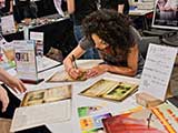 So many calendars to sign! © Robert Gary