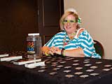 Krista Bricker mans the swag table. © Bruce Matsunaga