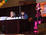 PJ Haarsma gets a call from actor Nathan Fillion, asking the crowd to “dance one” for him. © Bruce Matsunaga