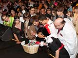 Dance-off participants pick out a prize. © Bruce Matsunaga