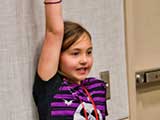 Peyton holds the sun up high. © Robert Gary