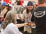 Todd Schumann of Hero Comics shows fanish enthusiasm over his autographed DVD. © Bruce Matsunaga