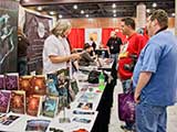 Adam Goldman of Mojo-Bone Software Studios asks PJ for an autograph. © Robert Gary