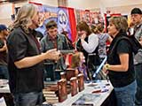 Denise listens “seriously” to PJ's incredulous tale of DVD signings. © Robert Gary