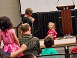 A little girl tells Denise that she likes to sing and dance. © Robert Gary